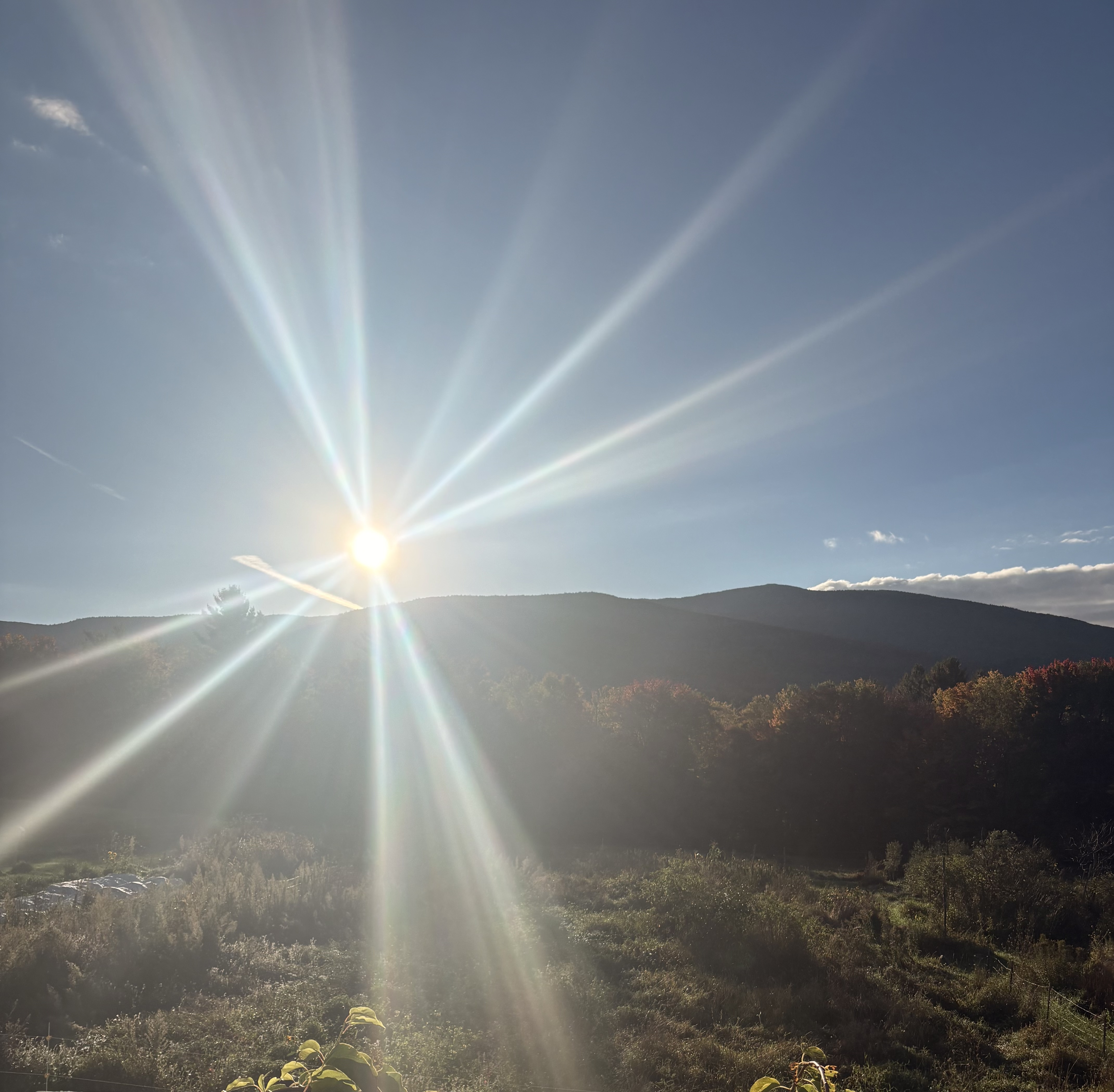 The sun bursting over a mountain ridge